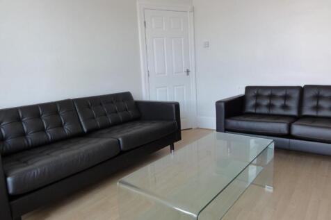 Modern living room featuring two black leather ...