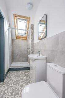 Bright and modern bathroom featuring a skylight...
