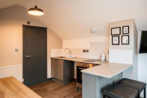 Modern and tidy kitchen area featuring a sleek ...