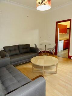 A cozy, well-maintained living room featuring c...