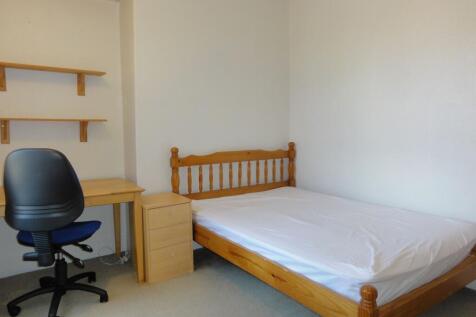 Bright, simply furnished single bedroom with a ...