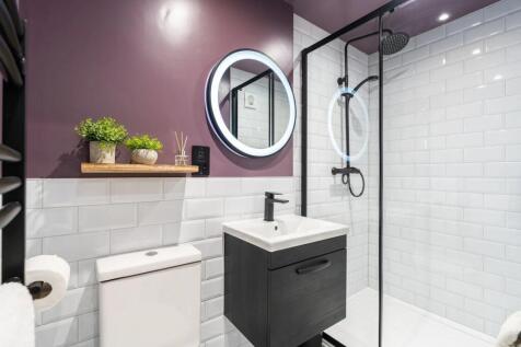 Modern bathroom featuring white subway tiles, a...