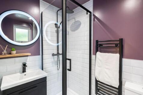 Modern bathroom featuring a sleek walk-in showe...