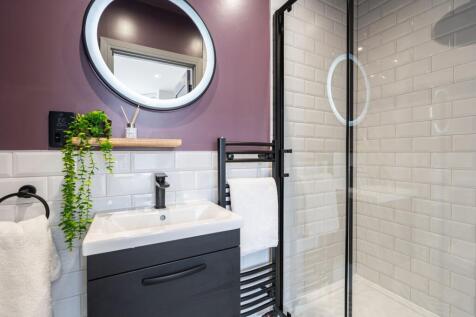Modern, clean bathroom featuring a stylish sink...