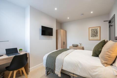 Bright and spacious master bedroom featuring a ...