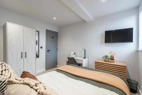 Bright, modern bedroom with a comfortable bed, ...