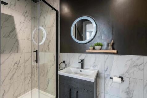 Modern bathroom featuring a sleek walk-in showe...