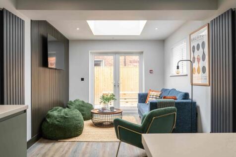 Modern and stylish living room featuring a comf...