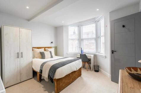 Bright and welcoming bedroom featuring a large ...