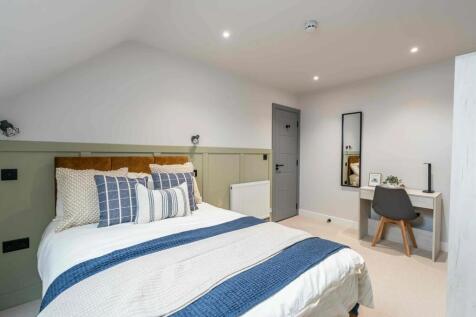 A stylish and inviting bedroom featuring a larg...