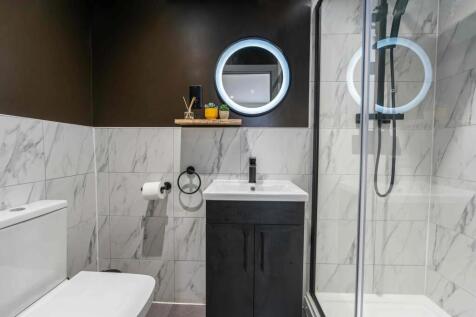 Modern bathroom featuring a sleek vanity, large...