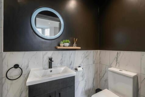 Modern bathroom featuring a sleek white sink wi...