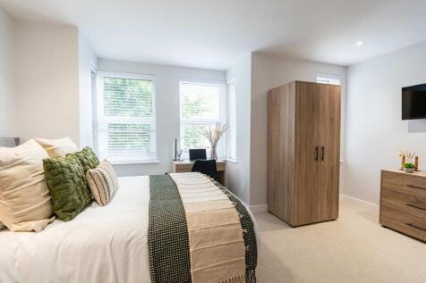 Bright and welcoming bedroom featuring a large ...