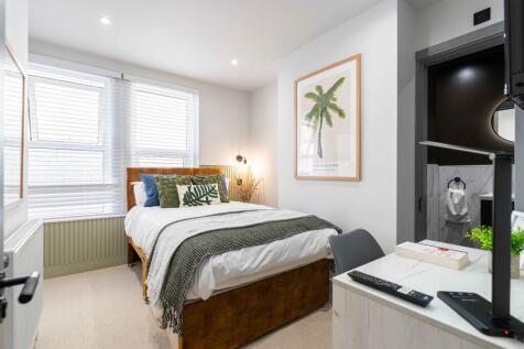 Bright and modern bedroom featuring a cozy doub...