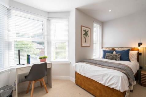 Bright and inviting double bedroom with a large...