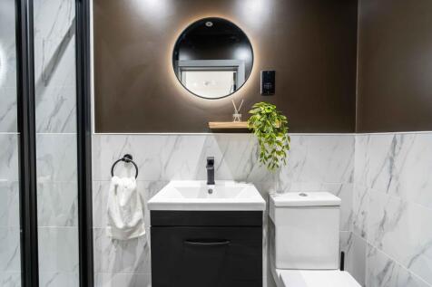 A modern, clean bathroom featuring a stylish bl...