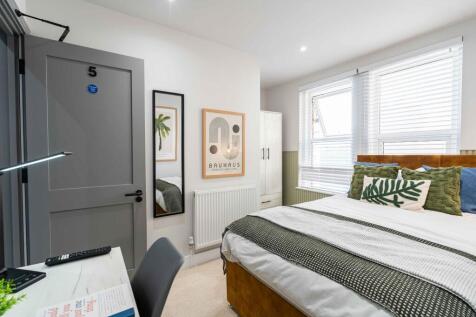 Bright and spacious master bedroom featuring a ...