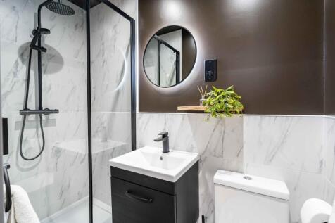 Modern bathroom featuring a sleek shower with a...