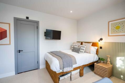 A modern double bedroom featuring a comfortable...