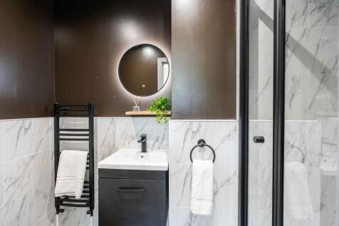 Modern bathroom featuring a sleek vanity with a...