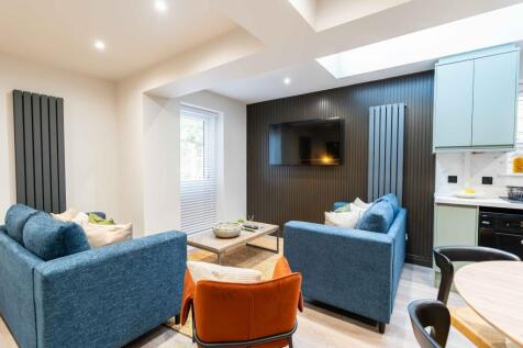 A modern and bright living room featuring cozy ...