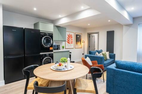 Bright and modern living room featuring a comfo...