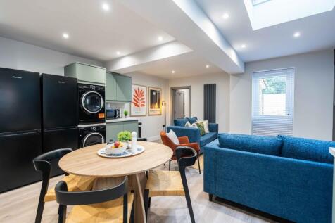 Modern, bright living room featuring a spacious...