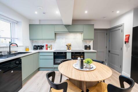 Modern and stylish kitchen featuring pastel gre...
