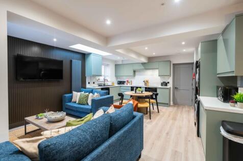 A modern, spacious living room featuring comfor...