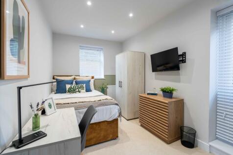 A bright and inviting double bedroom featuring ...