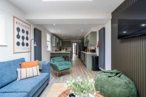Bright and stylish living room featuring a comf...