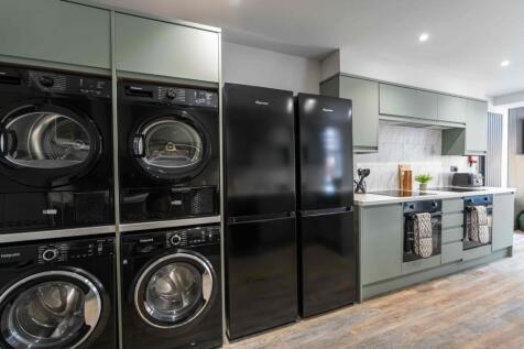 Modern kitchen featuring sleek cabinetry, a mar...