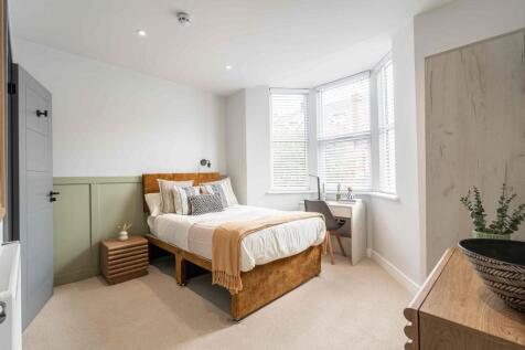 Bright and inviting bedroom featuring a comfort...