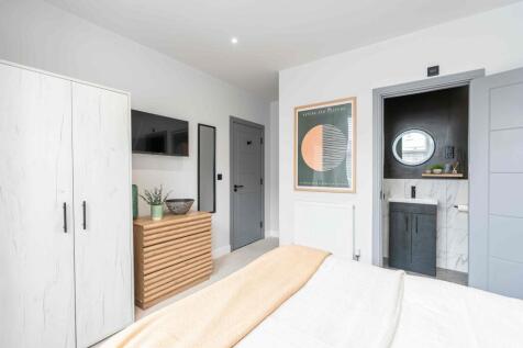 A modern, well-maintained bedroom featuring a c...