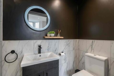 Modern and stylish bathroom featuring a sleek w...