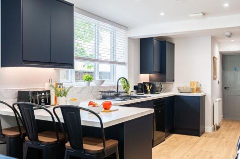 Modern and stylish kitchen featuring sleek dark...
