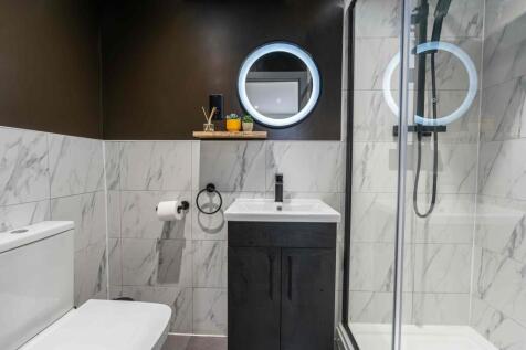 Contemporary bathroom featuring a sleek vanity ...