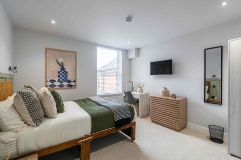 Bright and spacious living room featuring a lar...