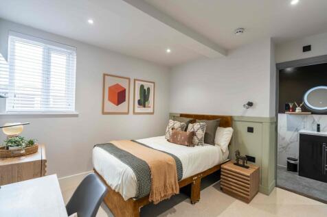 A beautifully decorated bedroom featuring a lar...