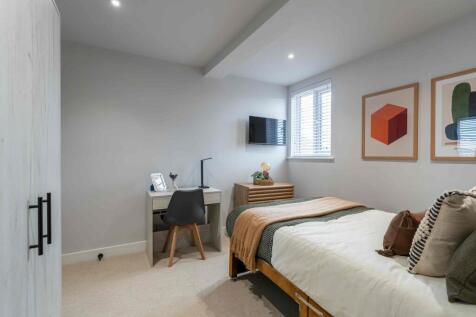 Bright and inviting bedroom featuring a comfort...