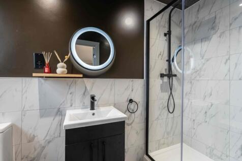 Modern bathroom featuring a sleek black and whi...
