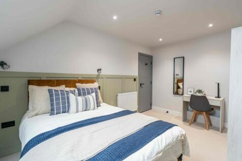 A cozy and well-maintained bedroom featuring a ...