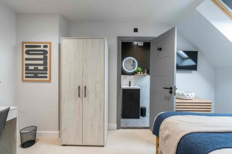 A modern, well-maintained bedroom featuring sof...