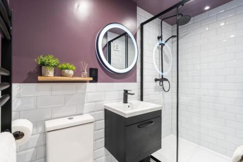 Modern bathroom featuring a spacious shower are...