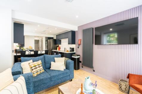 Bright and modern living room featuring a comfo...