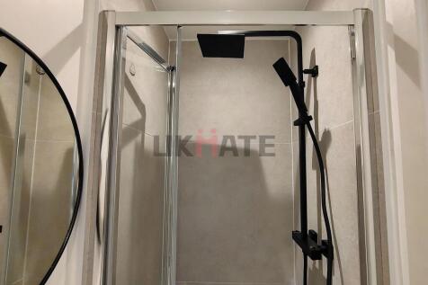 A modern bathroom featuring a walk-in shower wi...
