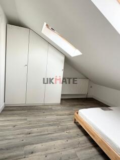 A bright and tidy bedroom featuring a white war...