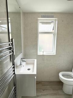 A bright and modern bathroom featuring a sleek ...