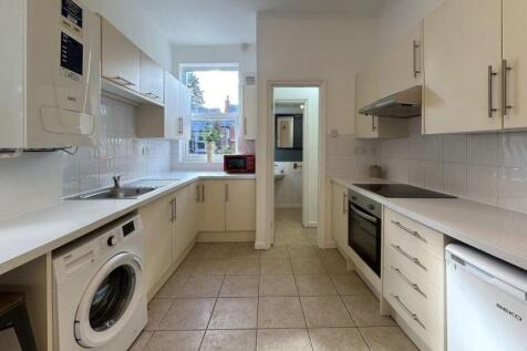 Bright and modern kitchen with ample storage, p...