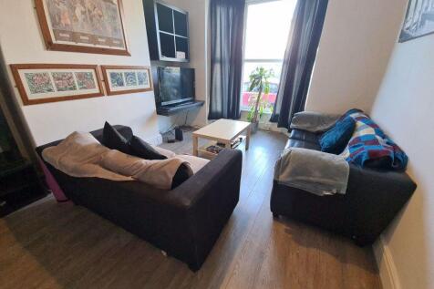 A cozy and well-kept living room featuring two ...